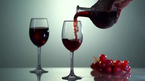 Close-up of sommelier pouring red wine into decanter in slow motion. Wine Stock Footage 153319672