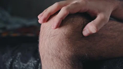 Close-up of a sore exposed knee on a man's leg. Knee joint contusion from he Stock Footage 337785131