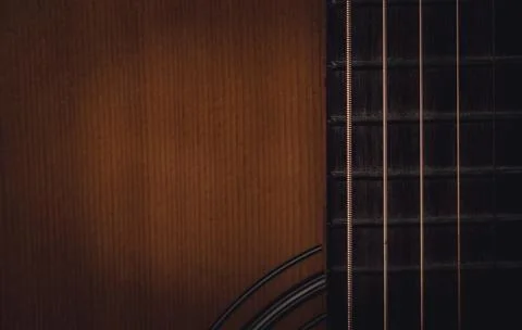 Close up sound board and strings of old acoustic guitar and dark tone vintage Stock Photos