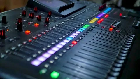 Close-up of a sound mixer showcasing knobs, sliders, and vibrant lights Stock Footage 296729015