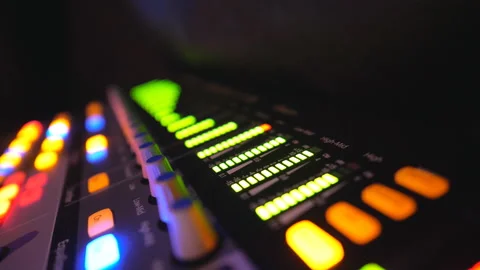 Close up of soundboard with knobs and green color equalizer in night club 스톡 동영상 127993634
