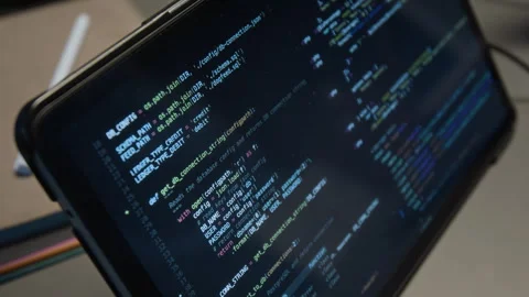 Close-up of Source Code Displayed on Screen of Digital Tablet in Dim Light Stock Footage 329616223