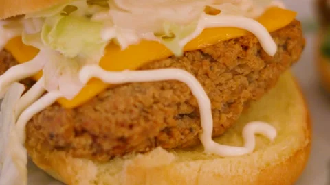 Close-up of Southern Fried Chicken Burger with Cheese, Lettuce and Mayonnaise. 動画素材 345102761