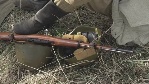 Close-up of a Soviet soldier from World War II sitting on the ground Stock Footage 89678786