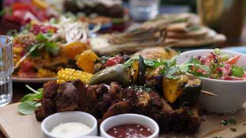 Close up of soy meat and vegetable barbecue served with sauces and a side salad Stock Footage 139685779