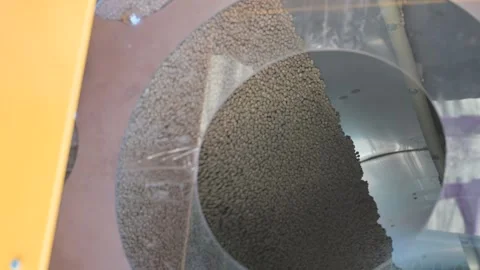 A close-up of soybeans is processed in a metal drum Stock Footage 345599227