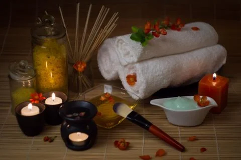 Close-up. Spa still life. Sea salt bath, massage oil, candles, flowers and to Stock Photos