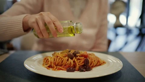 Close up of spaghetti alla puttanesca with tomato sauce, black olives, capers, Stock Footage 332650300