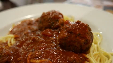 Close Up of Spaghetti and Meatballs with Savory Tomato Sauce on a White Plate Stock Footage 345688289