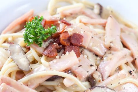 Close up spaghetti carbonara which has mushrooms, ham and black pepper mix an Stock Photos