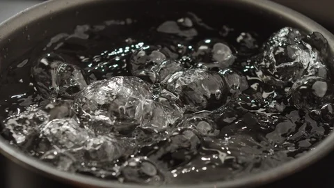 Close-up of spaghetti falling into boiling water. Slow motion video Stock Footage 124067655