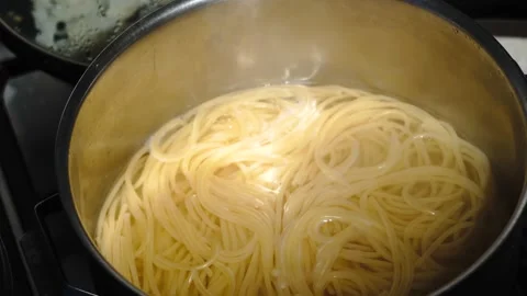 Close-up of spaghetti pasta In boiling hot water in steel pan. Preparation for Stock Footage 134733121