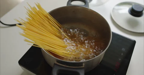 Close up of Spaghetti Pasta Boiling in Pot on Electric Portable. Stock Footage 341298253