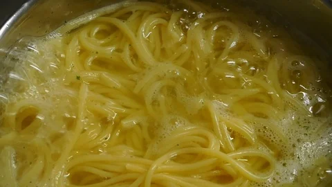 Close-up: spaghetti pasta cooked in boiling water in slow motion Stock Footage 102062054