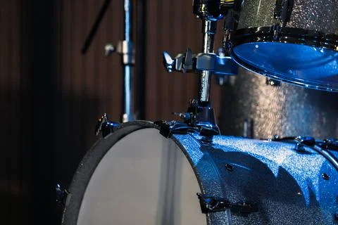 Close-up of a sparkling blue drum kit on a dimly lit stage Stock Photos