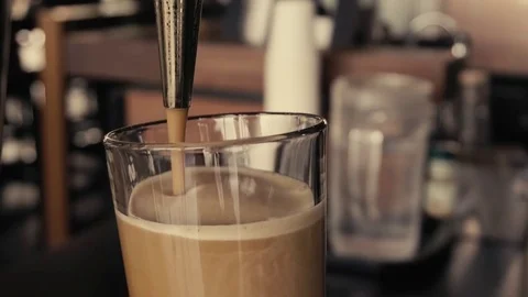 Close up of Sparkling Nitro Cold Brew Coffee pouring to glass and ready to drink Stock Footage 84293273
