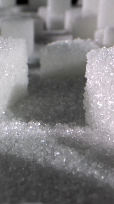 Close-up of sparkling sugar cubes arranged in creative patterns on a dark Stock Footage 320271883