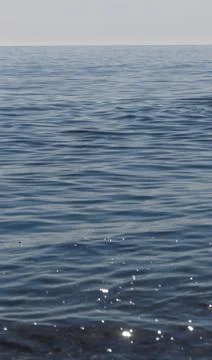 Close up of sparkling surface of sea with waves and sky background Stock Photos