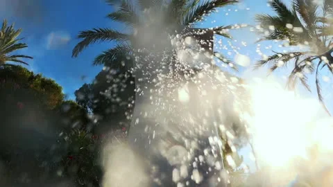 Close up of sparkling water droplets falling from an outdoor shower, creating a Stock Footage 343002130