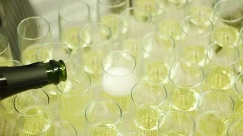 A close-up of sparkling wine being poured into glass glasses. Media. Festive Stock-Footage 140753067