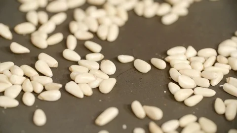 Close-up of spatula roasting pine nuts in cooking pan at kitchen - Paris, France Stock Footage 129206848