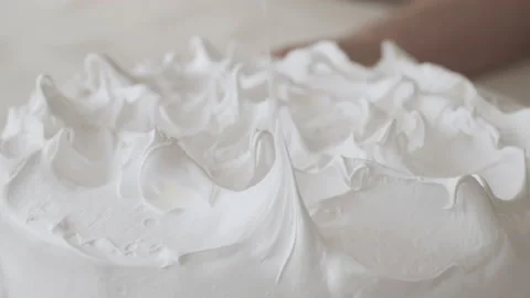 Close up of spatula shaping white meringue cake topping Stock Footage 240052684