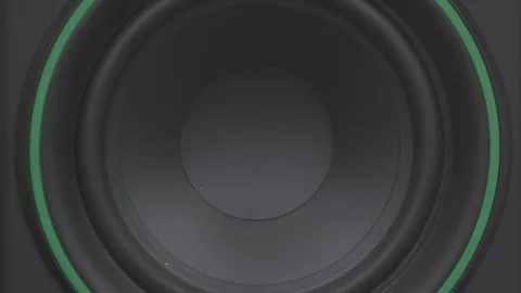Close up of a speaker woofer bouncing from audio Stock Footage 89878300