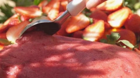 Close-up of the special ice-cream spoon scooping a fresh strawberry ice cream Stock Footage 200134255