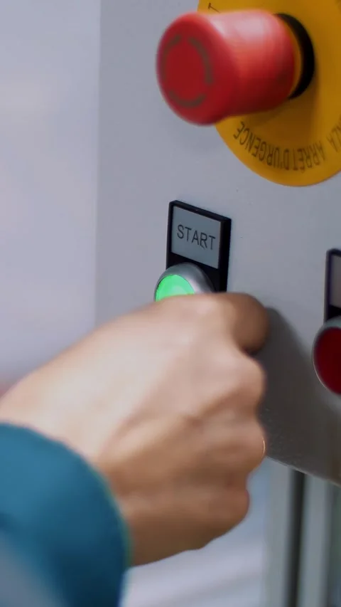 Close-up, on a special shield, the hand presses the green start button, next to Stock Footage 319482058
