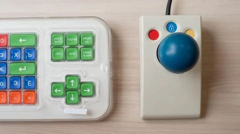 Close-up of a specialized computer mouse and keyboard for people with cerebral Foto stock