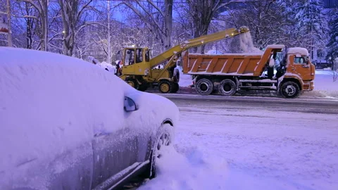 Close-up specialized snowplows unload snow into a truck. Snow plow outdoors. Stock Footage 101173598