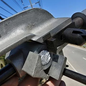 Close up of specialized wire stripping tool removing insulation. Stock Photos