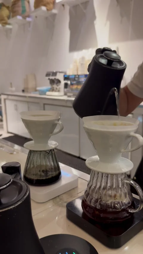 Close up of specialty coffee brewing process using two V60 ceramic drippers Stock Footage 337636013