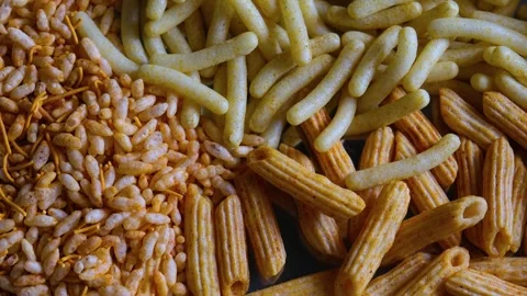 Close-up of Spiced Corn Puff Sticks in White Bowl Video stock 331986662