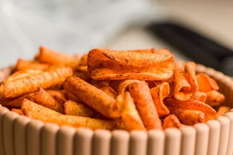 Close-Up Of Spicy Corn Snack Chips In A Bowl With Chili Seasoning And Crunc.. Stock Photos