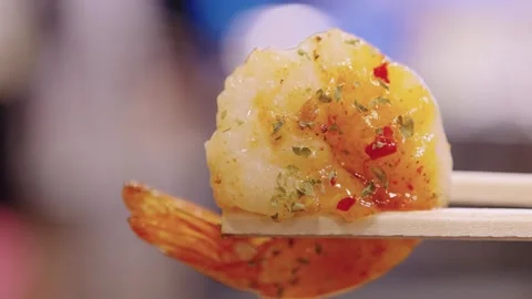 Close-Up of Spicy Grilled Shrimp Held by Chopsticks [1] Stock Footage 337440502