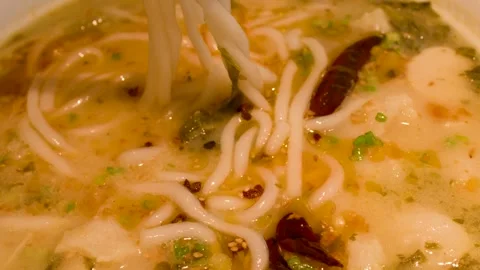 Close Up of Spicy Noodle Soup with Fish Balls and Chili Stockbeeldmateriaal 337768853