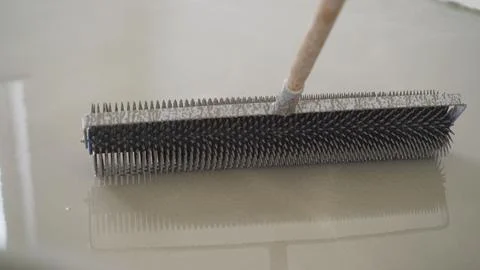 Close up of spiked roller used for leveling self leveling epoxy flooring co.. Stock Photos