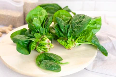 Close-up of spinach on the kitchen table on a light background Stock Photos