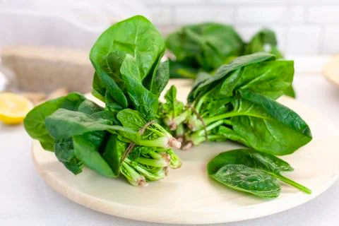 Close-up of spinach on the kitchen table on a light background Stock Photos