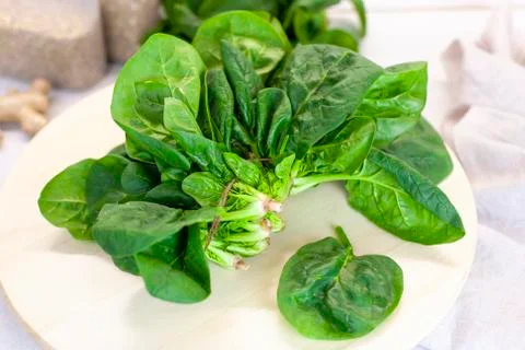 Close-up of spinach on the kitchen table on a light background Stock Photos