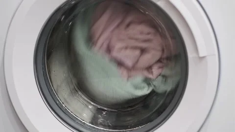 Close-up of spinning drum laundry machine. Video stock 168415568