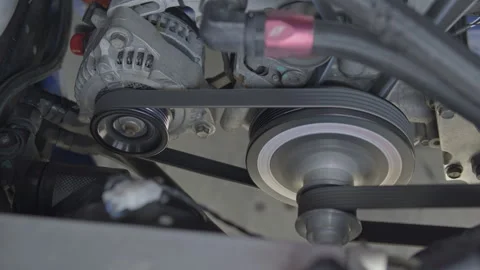 Close-up of spinning engine pulleys and alternator belt Stock Footage 340609962