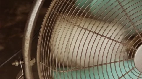 Close-up spinning fan blades creating cooling air flow Stock Footage 320129207