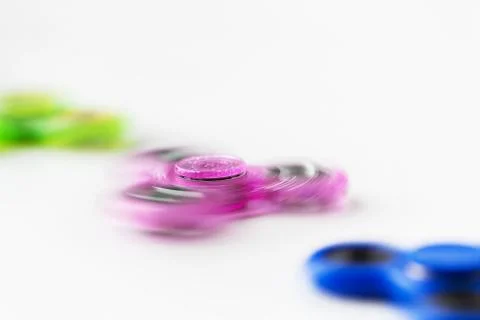 Close up of spinning fidget spinners Stock Photos