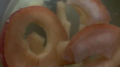 Close up of spinning Pieces of Apple in a jar of Tea 스톡 동영상 146928009