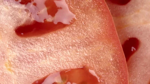 Close-Up of Spinning Red Tomato Slice Video stock 330778775