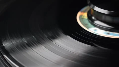 Close-Up of Spinning Vinyl Record on Turntable in Low Light Stock Footage 333756908