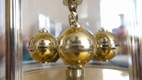 Close up of spinning weights on a dome style carriage clock Stock Footage 108038788