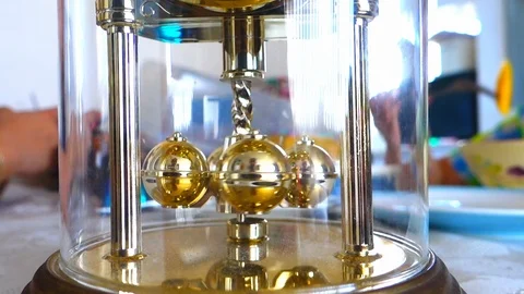 Close up of spinning weights on a dome style carriage clock Stock Footage 108038790